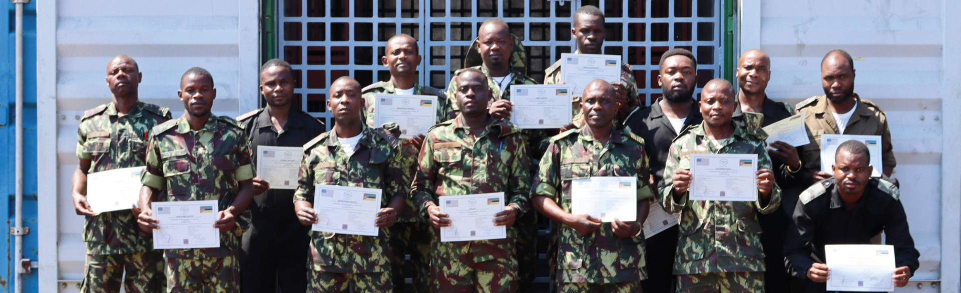 14 security personnel trained in weapons and ammunition management pose with their certificates