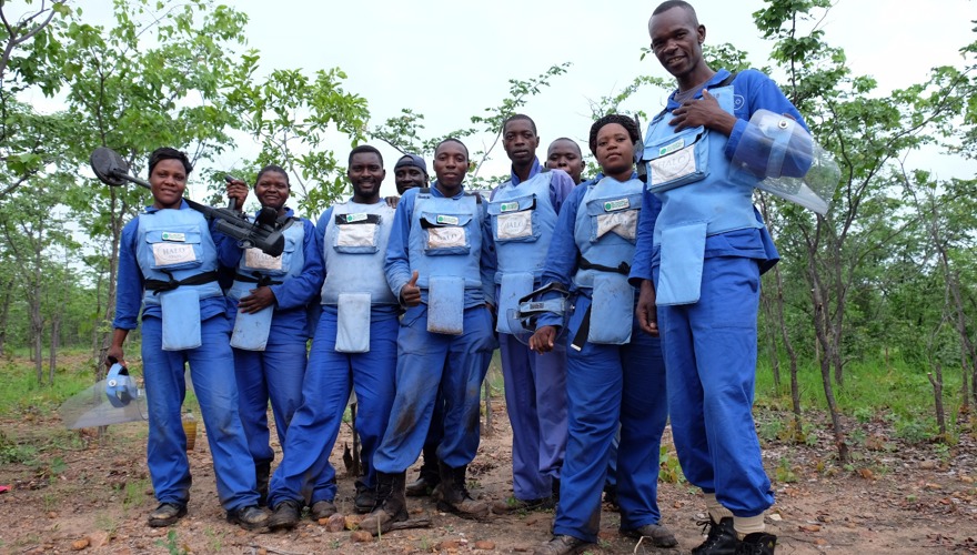 A team of deminers stand together in HALO PPE in Zimbabwe