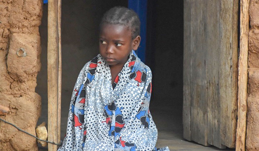 Young girl sits in a doorway in Angola