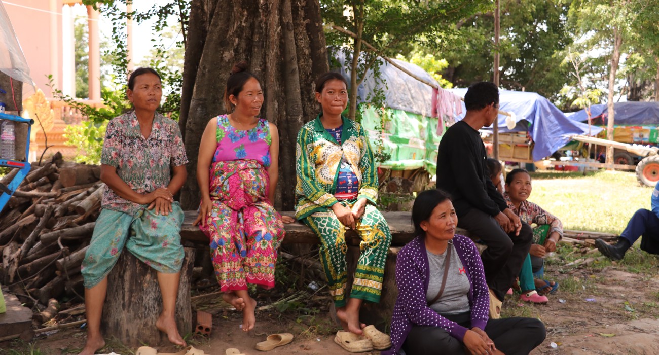 Internally displaced people of the Siem Reap Province sit outside