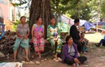 Internally displaced people of the Siem Reap Province sit outside