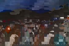 Locals gather outside late at night in Khost