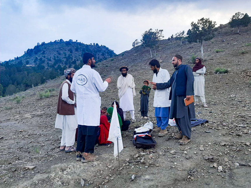 HALO medical staff having a discussion with Khost residents on a hill
