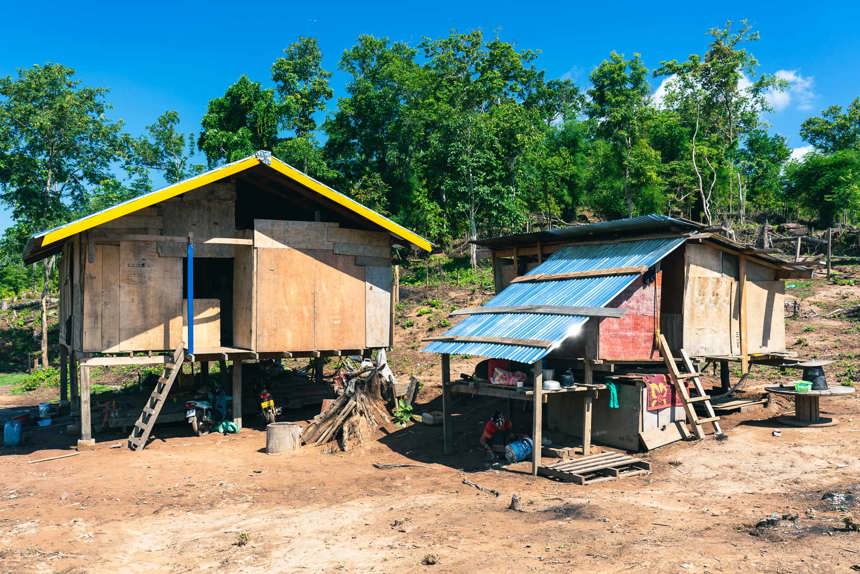 Two Village houses in Vangkhot with trees behind them