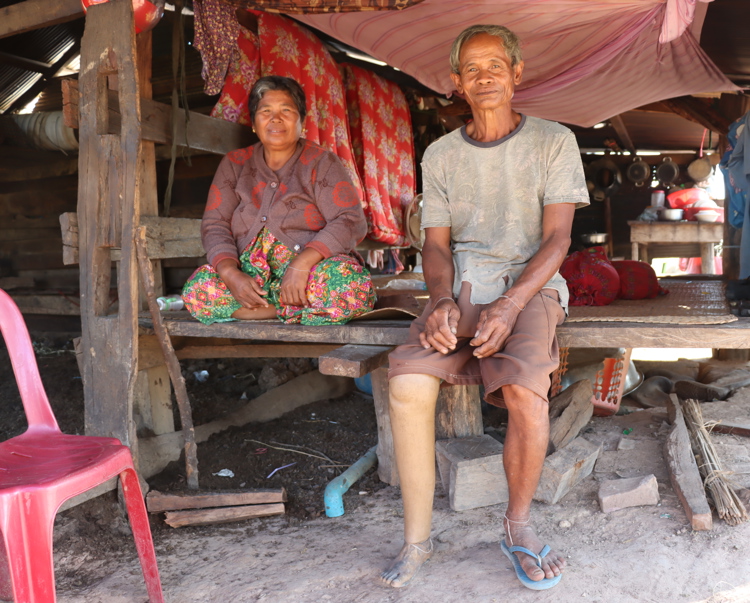Cambodian man and woman seat on a bench