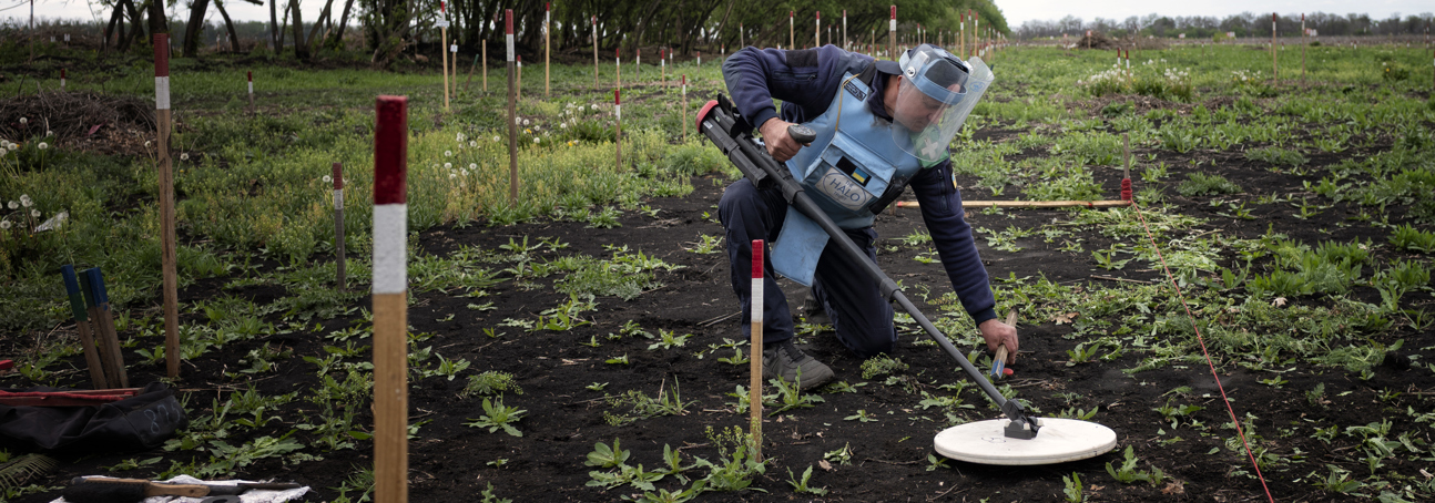 HALO Deminer on a minefield in Mykolaivka, Ukraine - detector in hand