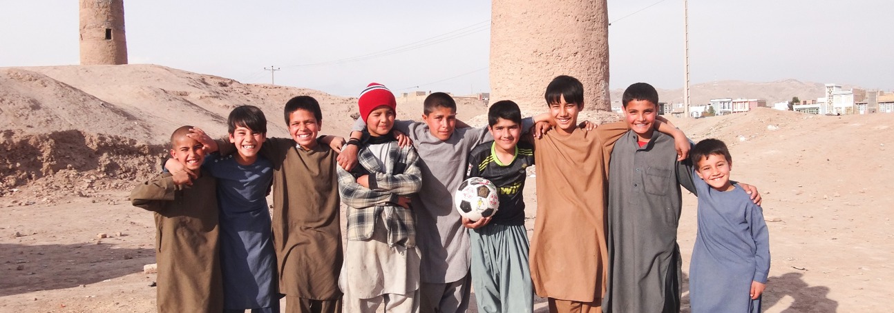 A group of children stand in front of the Minarets in Herat, following clearance of explosives by HALO