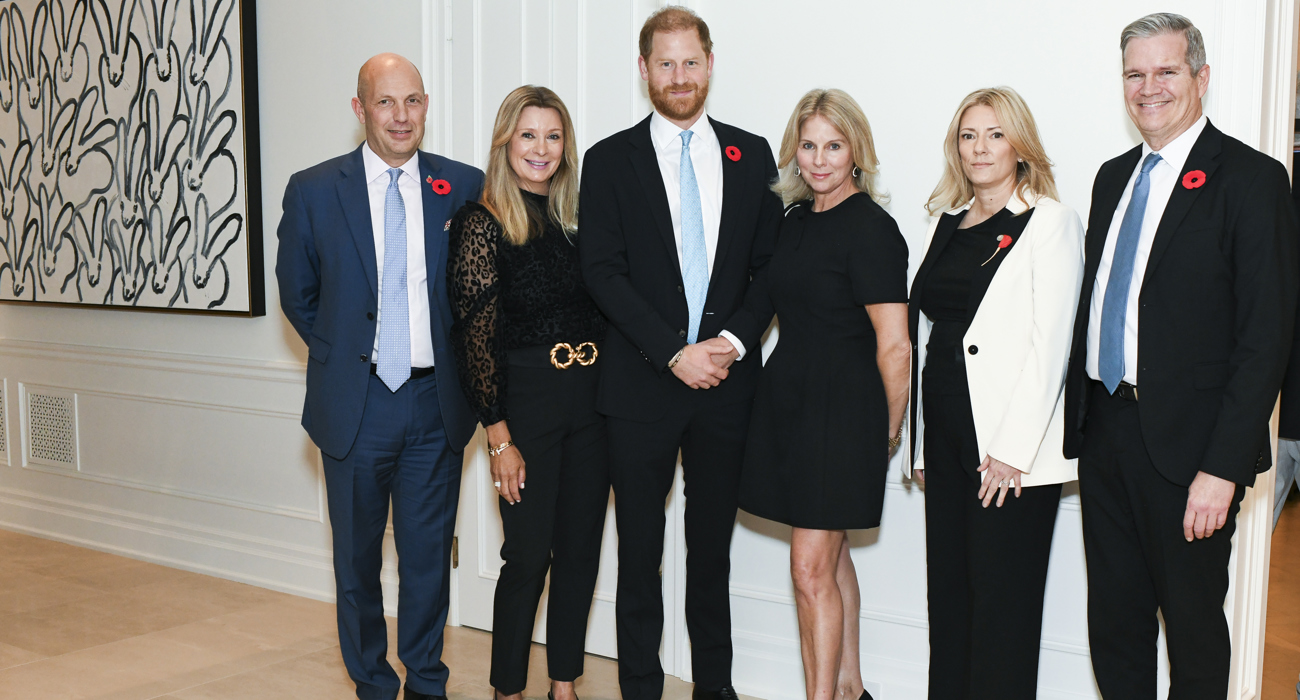 Prince Harry, HALO leadership members, and representatives of Grapes for Humanity pose at an event