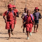 School kids walk through a rural area in Zimbabwe