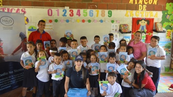 HALO staff pose with school children in a class