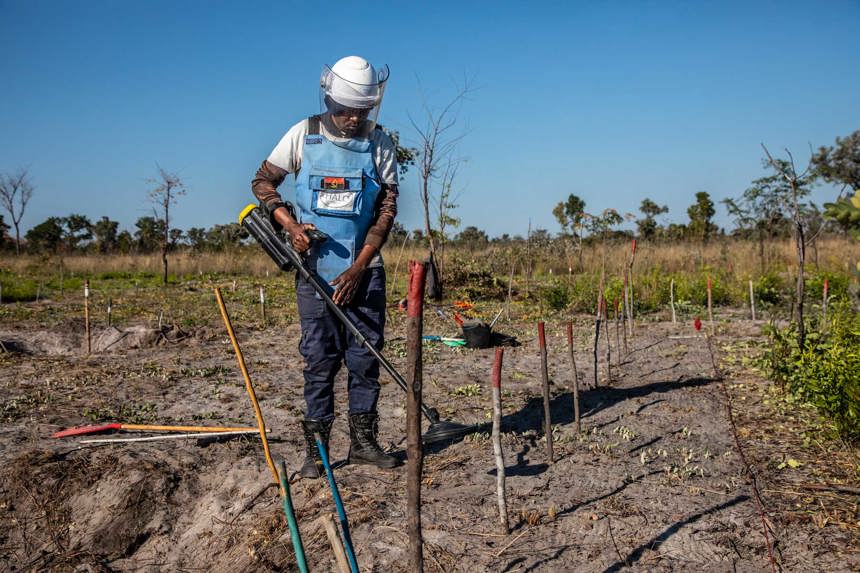 A deminer uses a detector in a mine lane in Cuito Cuanavale, Angola