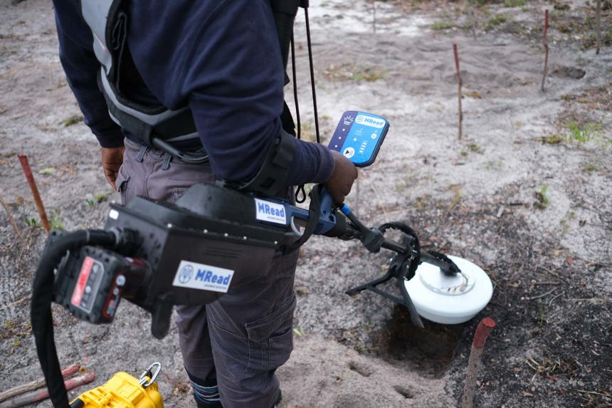 Close up image of a HALO Trust deminer trialling an innovative new detector produced by MRead in a rural minefield in Angola