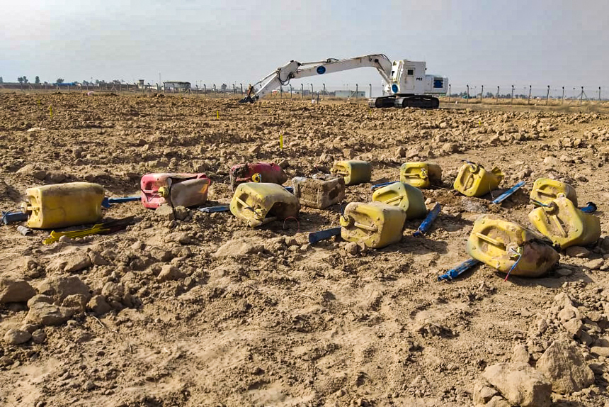 IEDs on the ground next to an armoured digger