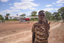 A man in front of a small plane in rural Angola
