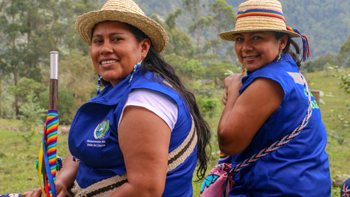 Two women from the Kwet Wala indigenous reserve sit outside