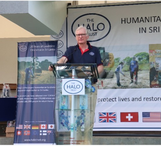 Stephen Hall, HALO Sri Lanka Programme Manager stands at a lectern in front of a HALO banner