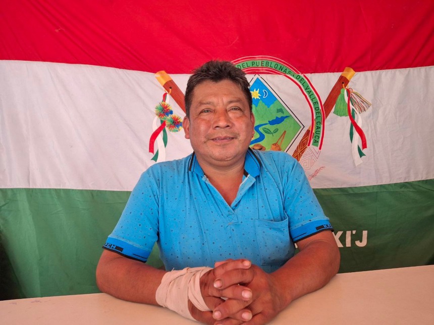 A middle-aged man sits in front of 