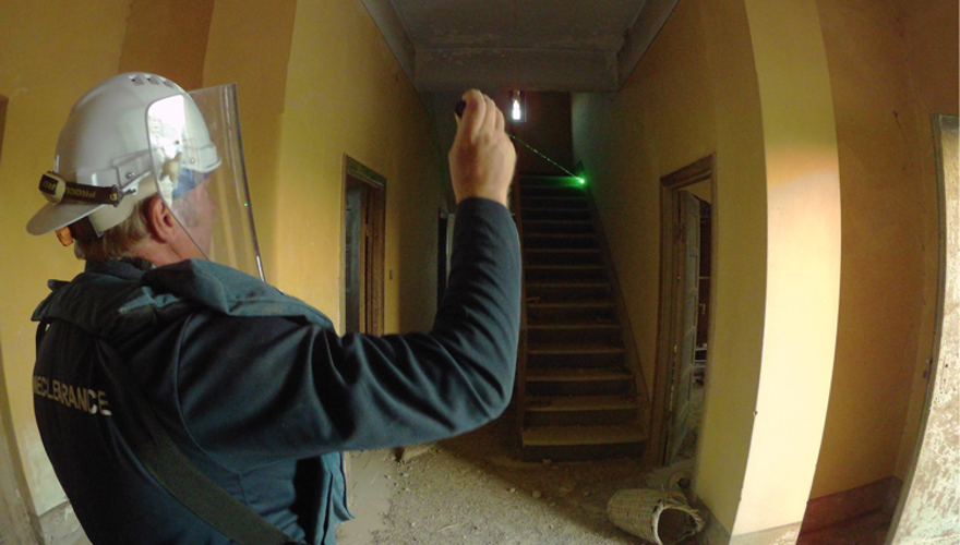 HALO staff member enters the church for the first time, holding a torch and wearing a visor
