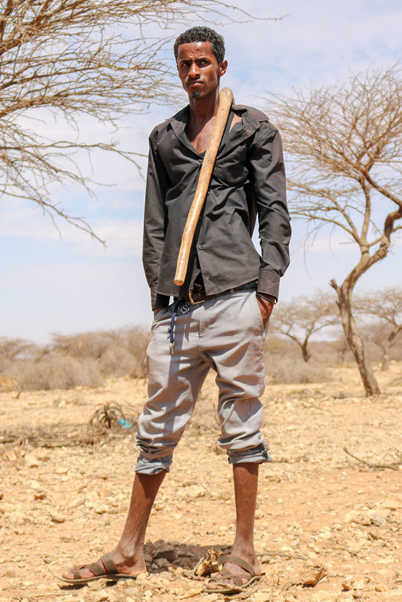 abdul nasser, a goat herder poses with his herding stick