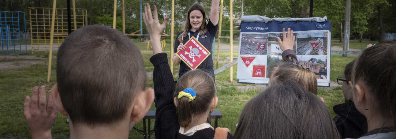 A HALO staff member leads a risk education session outside