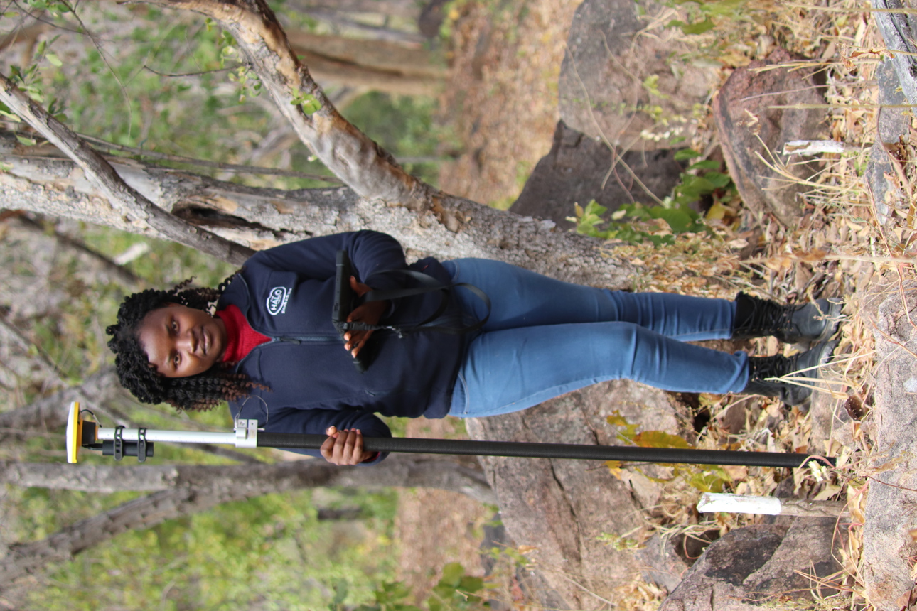 Delight Manyange, GIS Specialist, uses specialist technology to detect landmines