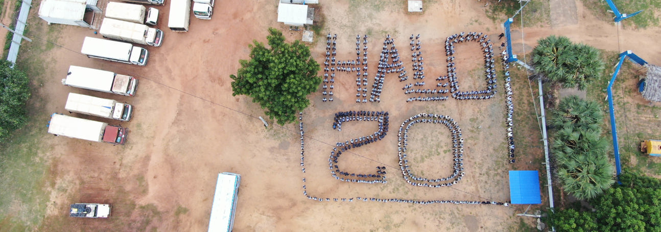 HALO Staff stand in formation to display "HALO 20" from a birds-eye view to mark 20 years of HALO in Sri Lanka