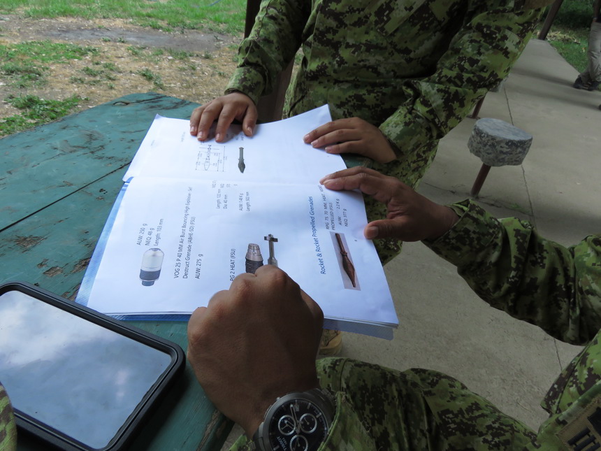 explosive ordnance disposal students check their notes to prepare for their final course evaluation