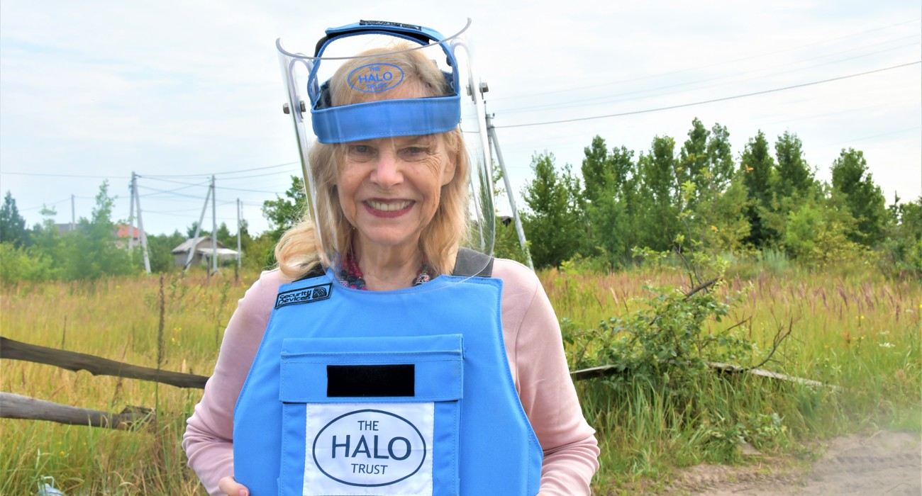 HALO Ambassador Mitzi Perdue smiles while wearing HALO deminer equipment in Ukraine