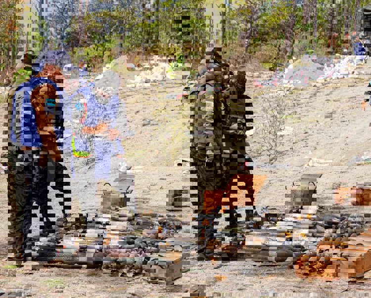 People in HALO vests gathered round a stockpile of weapons in Honduras