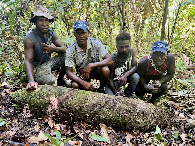 A HALO assessment team with an unexploded US 1,000lb bomb on the ridge