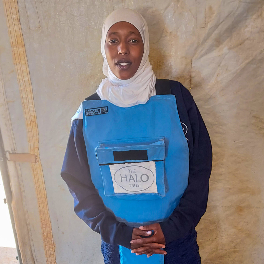 Ubah, a female deminer poses in her PPE