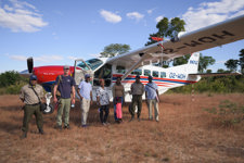 HALO Staff and MAF staff stand outside a small plane in Angola