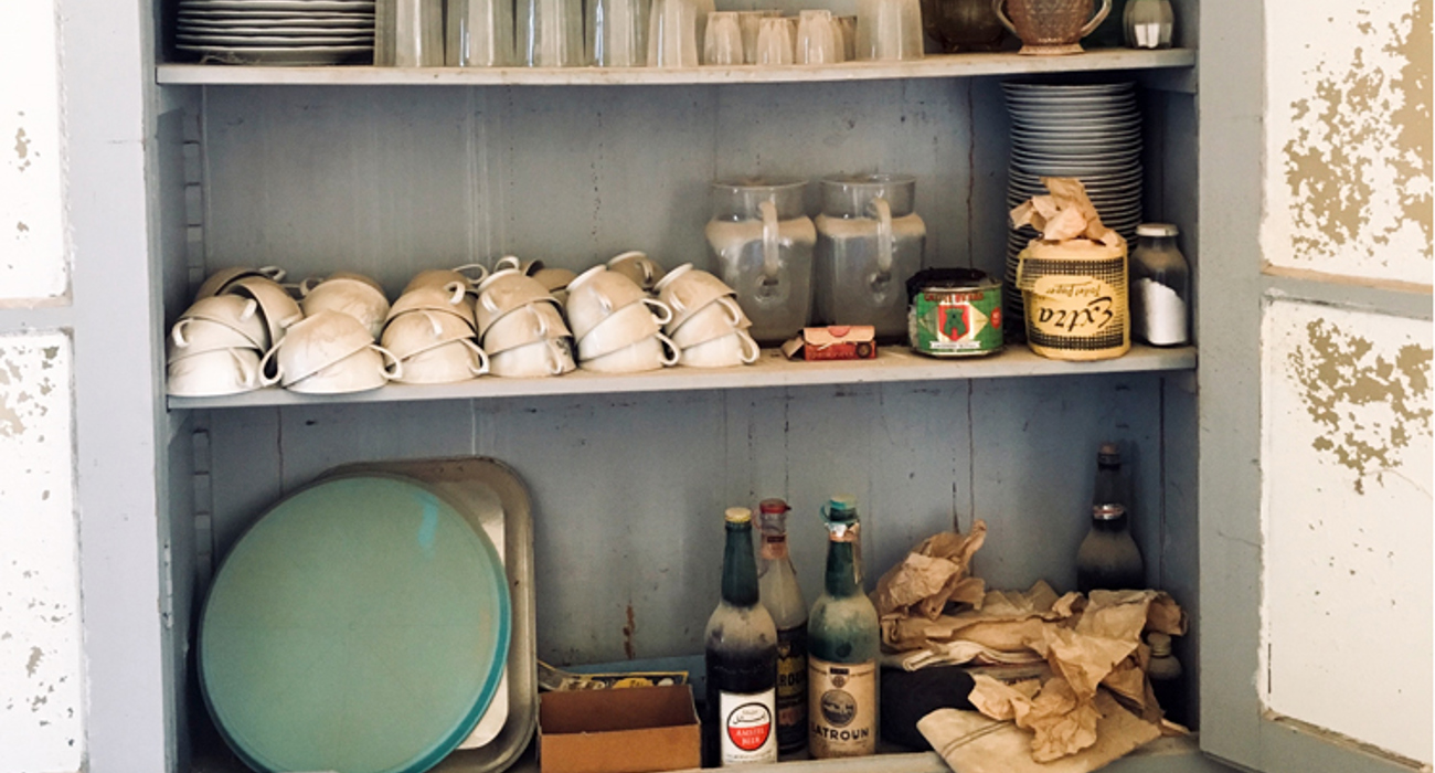 Neatly stacked crockery and bottles of beer inside a dresser in the Franciscan Church