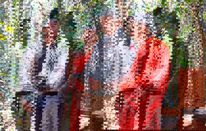 HALO staff discussing mine clearance with two monks
