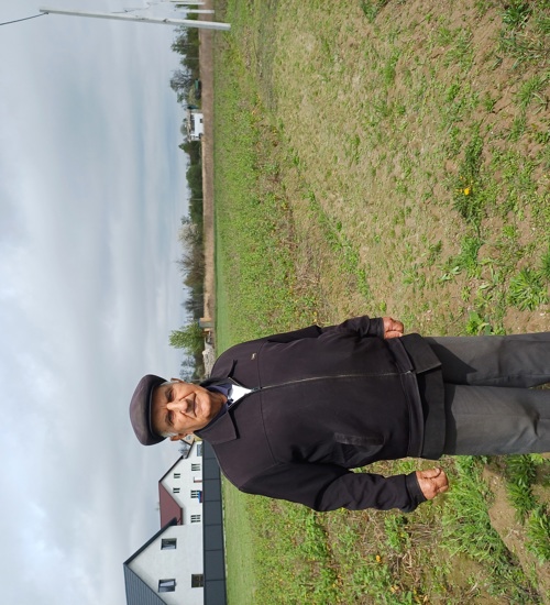 Ivan Ivanovych stands in front of his vegetable garden after HALO landmine clearance operations