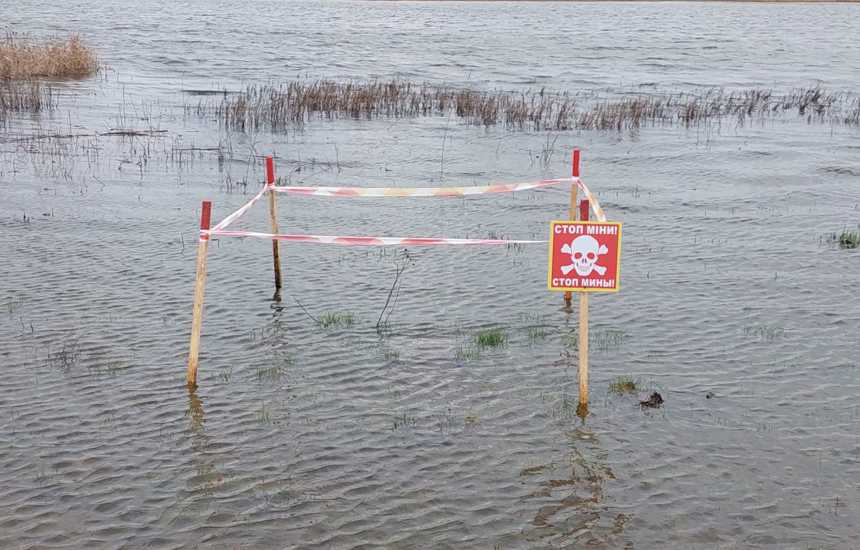 A fenced off square containing landmines in the middle of a flooded plain in Ukraine