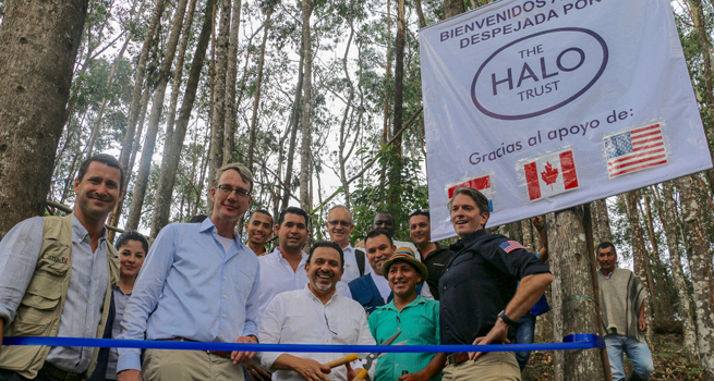 Jeroen Roodenburg stands with people from the Kwet Wala indigenous reserve to celebrate its handover