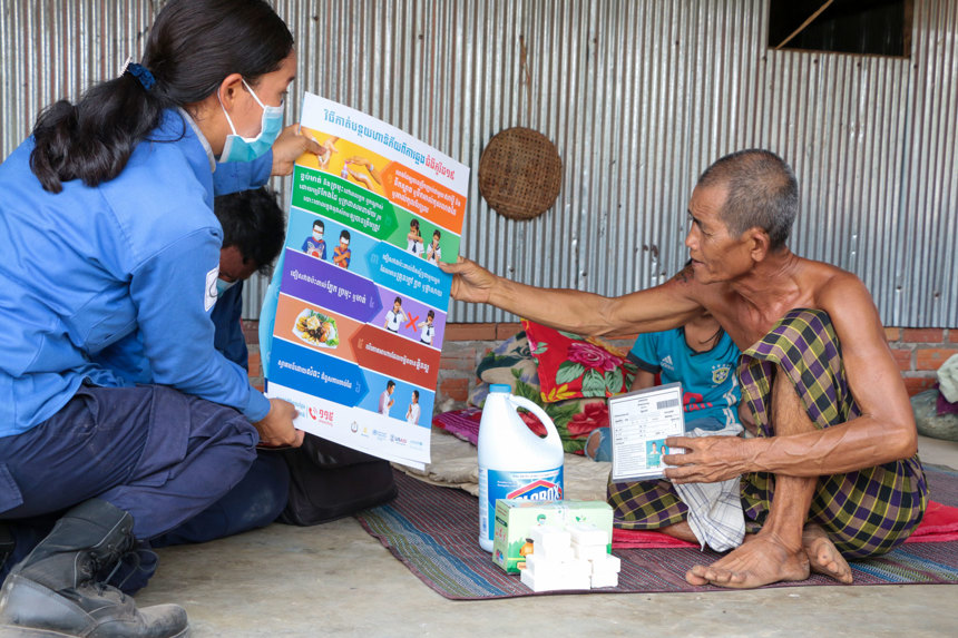 HALO staff member distributes COVID-19 information