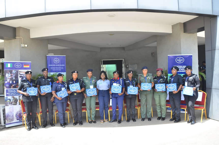 Nigerian law enforcers pose with HALO banners and posters