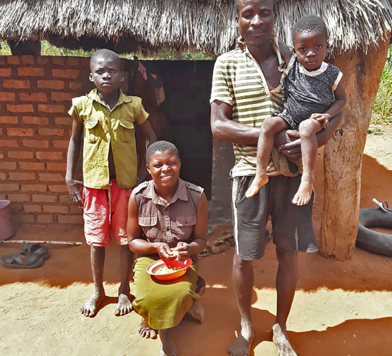 A family outside of their home in Zimbabwe