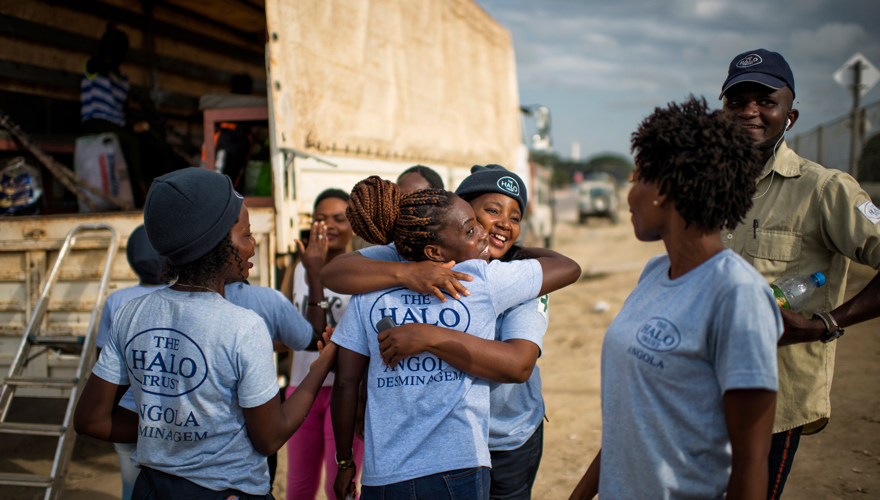 A female demining team hug in Angola