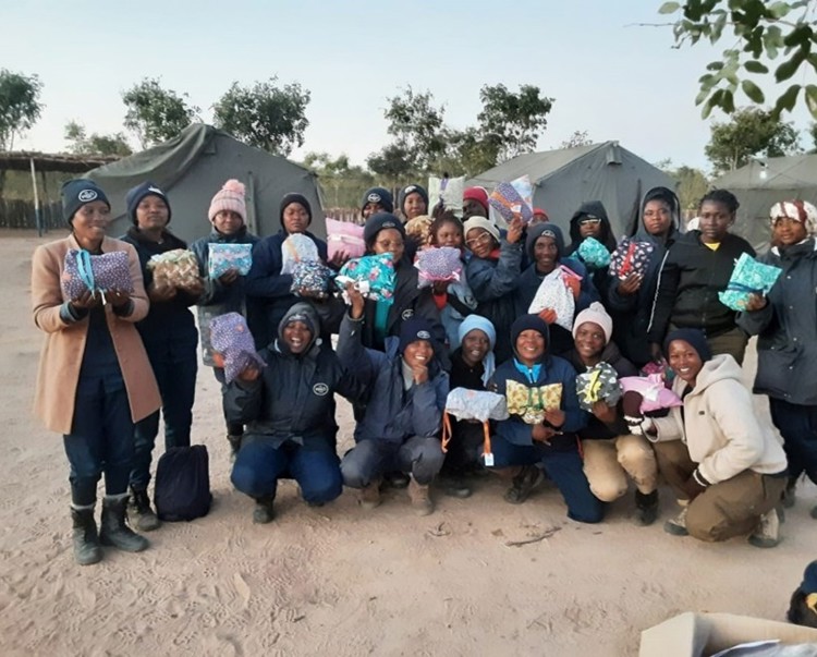 A large group of women in Angola pose with their personal hygiene kits