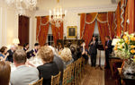 Harry, Duke of Sussex speaks in front of a podium before a room of seated guests
