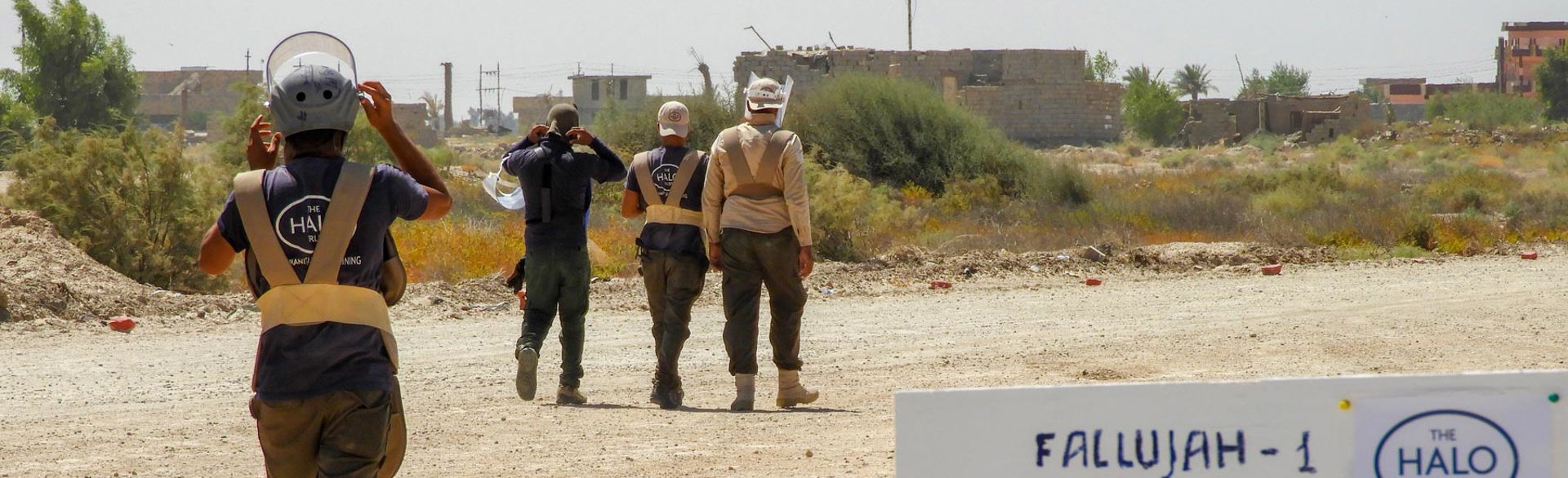 A team of deminers walk into a confirmed hazardous area in Fallujah, Libya