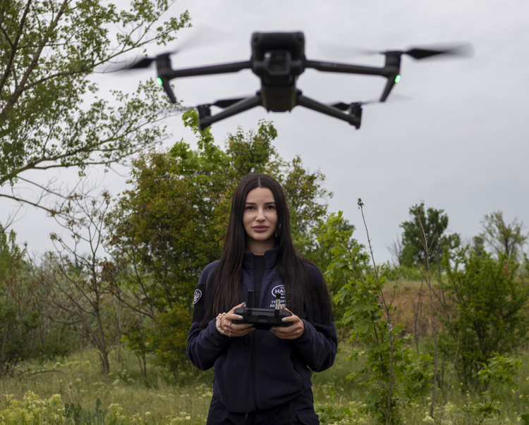A HALO staff member controls a drone