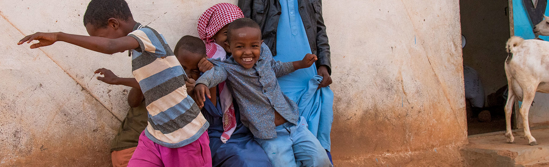 Children playing next to a wall in Somaliland