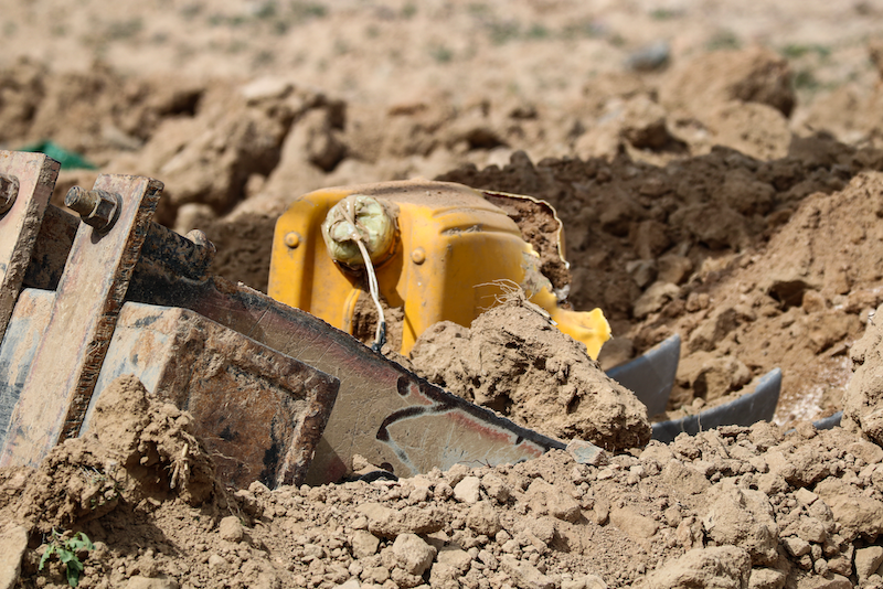 Close-up of a recently unearthed improvised explosive device in Afghanistan, highlighting the ongoing threat posed by unexploded ordnance