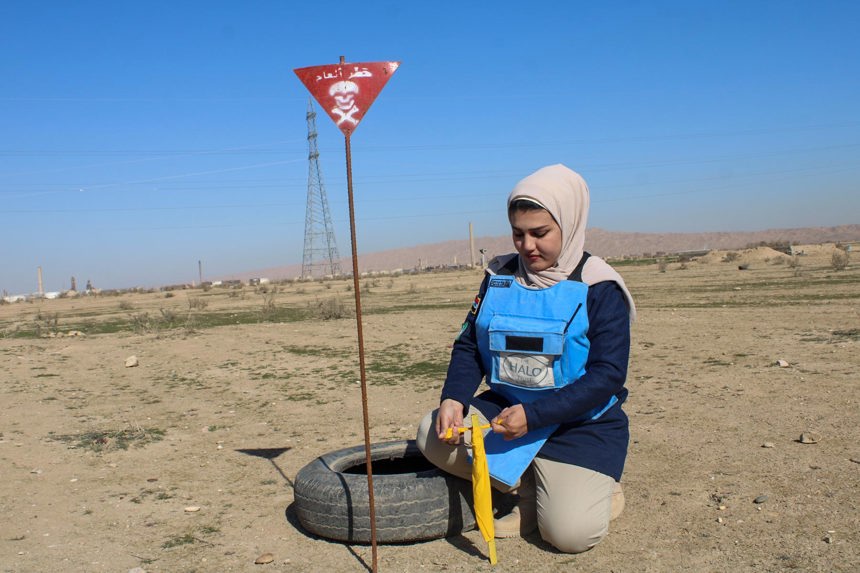 A deminer uses a tyre and stick to mark where an explosive was found