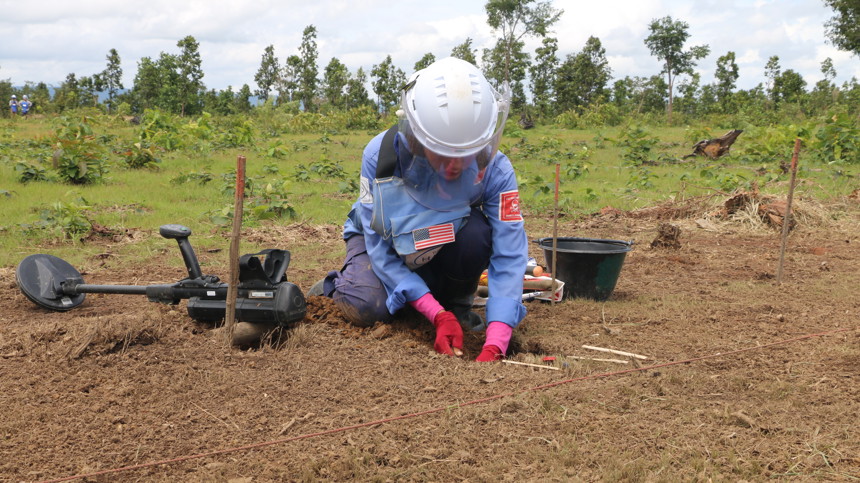 A HALO deminer excavates a landmine to make farmland safe in Cambodia